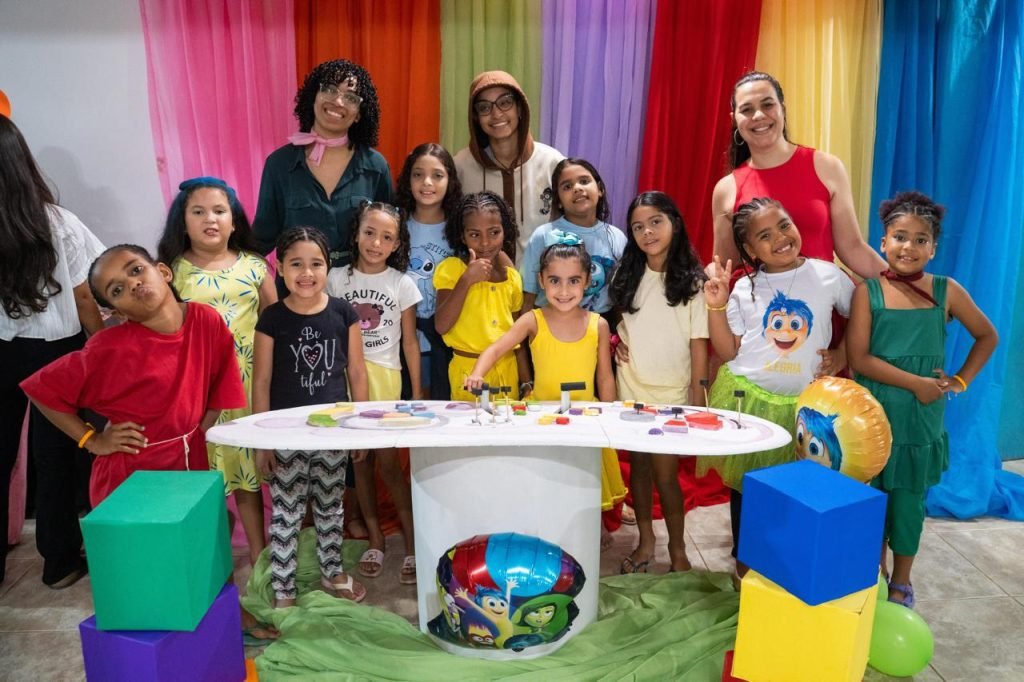 Children posing at camp event with volunteers