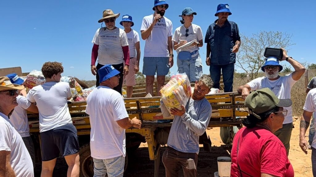 Volunteers unload food baskets from the truck for families in Buíque.