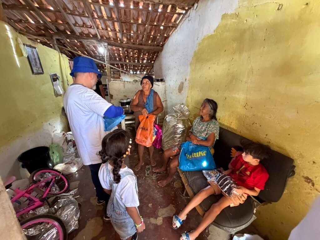 Visiting a family at home to deliver gifts and personal care kits.